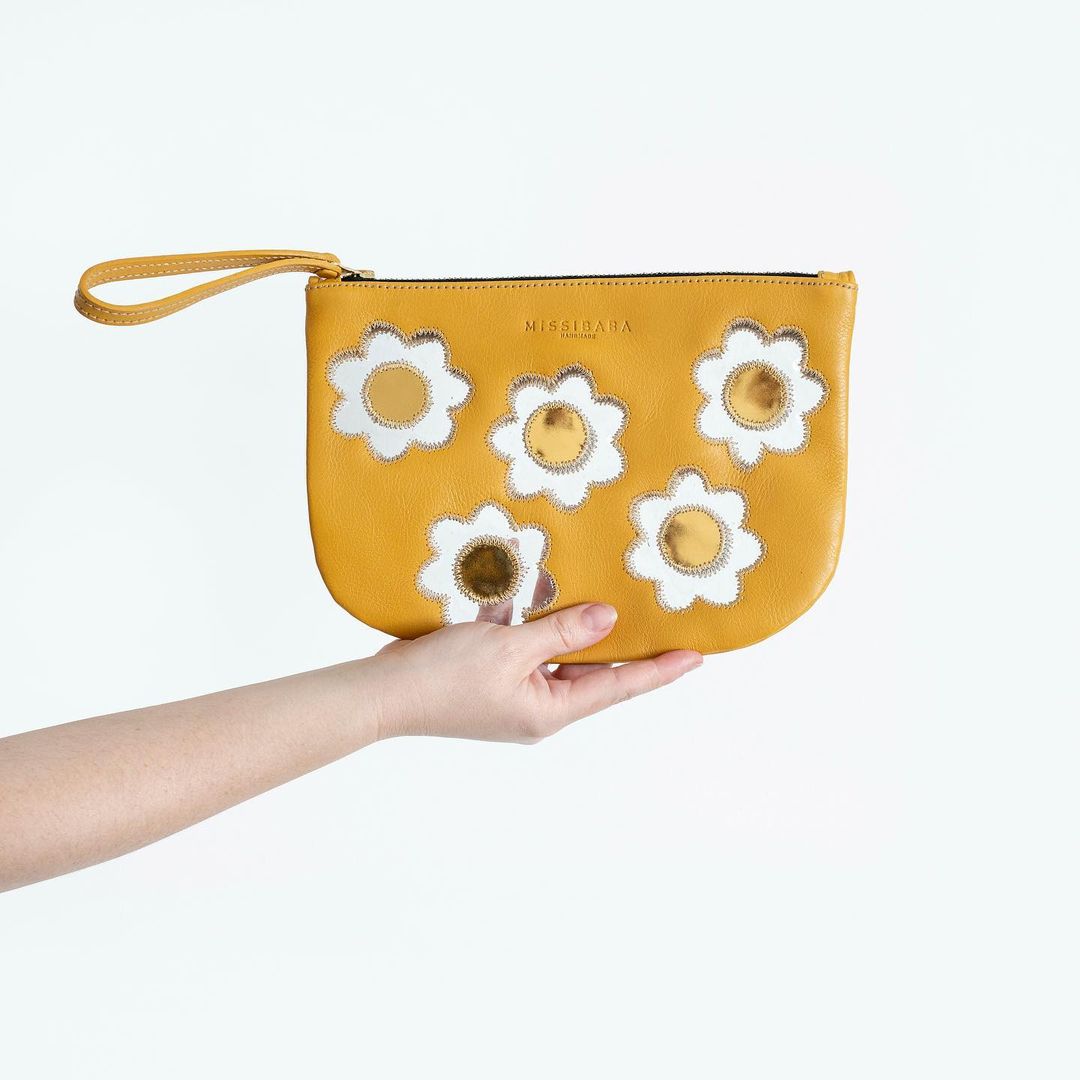 yellow leather women bag with white flowers and yellow centers with strap